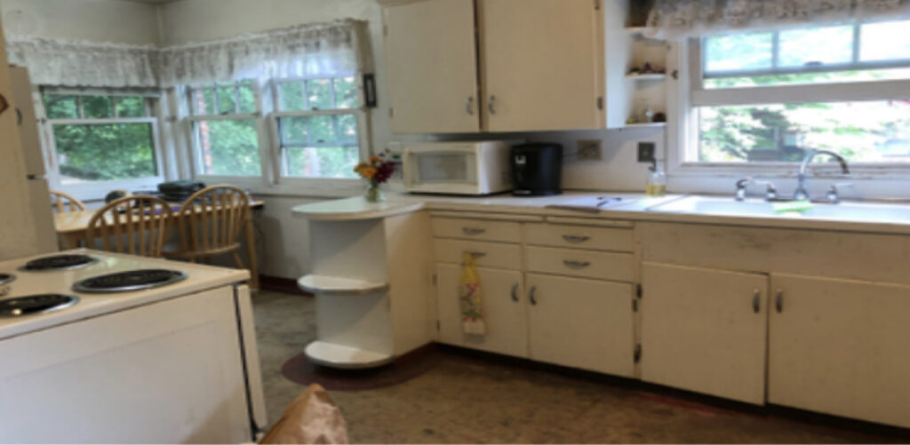 A "before" picture of a severely outdated kitchen.